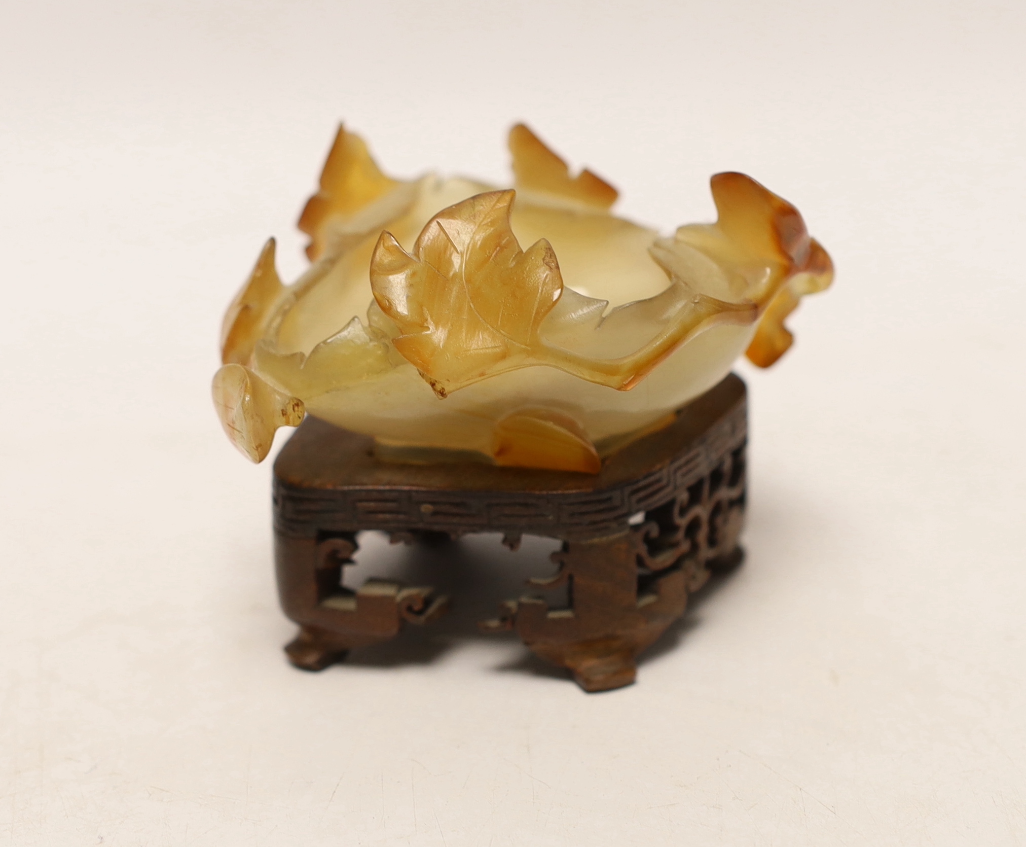 A Chinese agate brushwasher on carved stand, 8cms high including stand